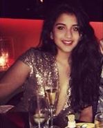 Radhika Merchant at a party enjoying a glass of champagne 