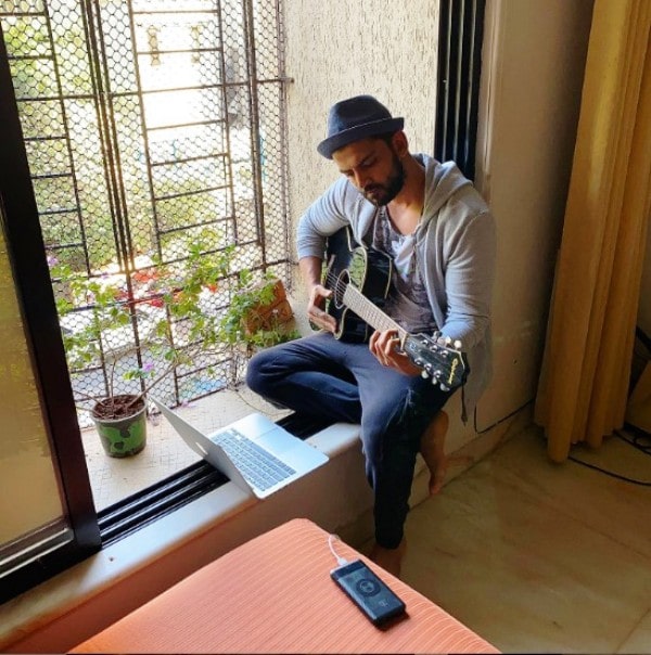 Zaheer Iqbal playing his guitar