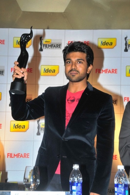 Ram Charan posing for a photo with his Filmfare Award South