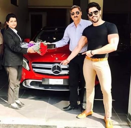 Shivashish Mishra standing near his Mercedes-Benz