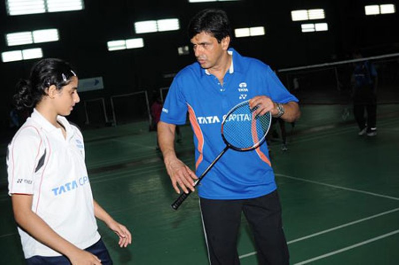 Prakash Padukone training a student at his academy