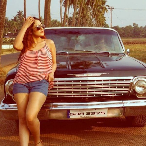 Shehnaz Kaur Gill posing with car