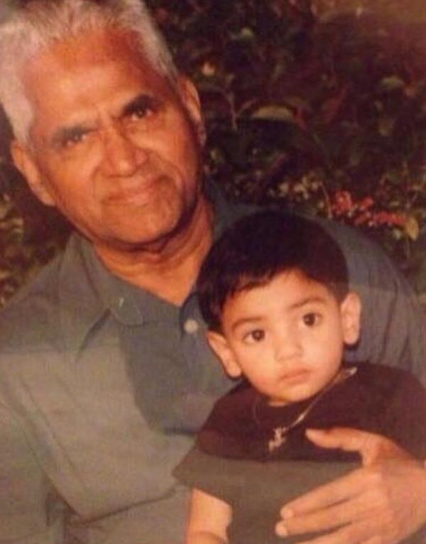 Suniel Shetty sitting in the lap of his father