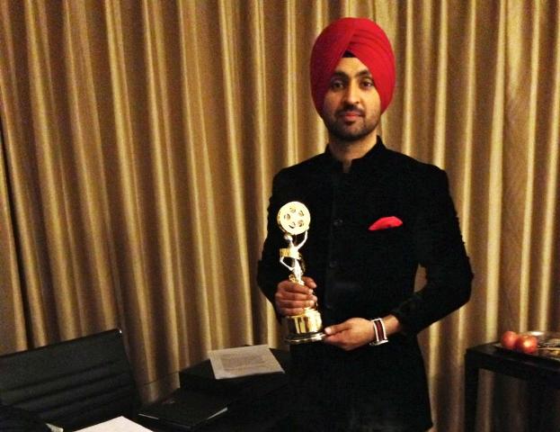 Diljit Dosanjh posing with the award