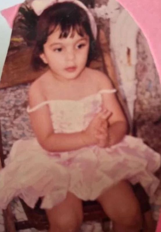 Kiara In An Off-Shoulder Dress In A Photo From Her Childhood