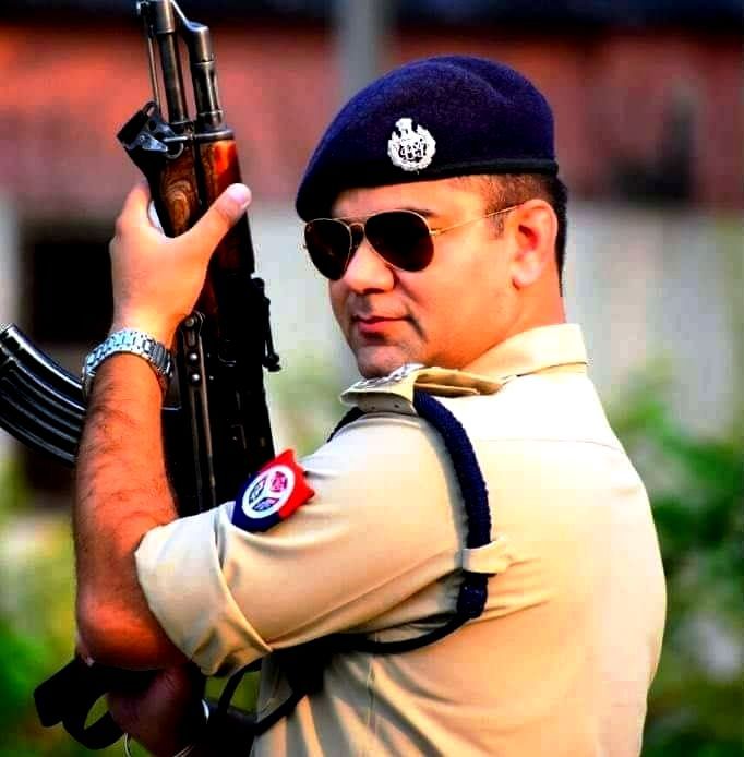 Ajay Pal Sharma posing with a gun