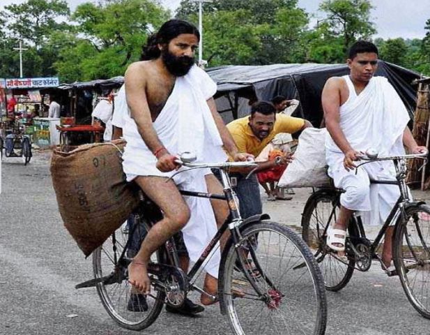 Acharya Balkrishna and Baba Ramdev while selling products on cycle