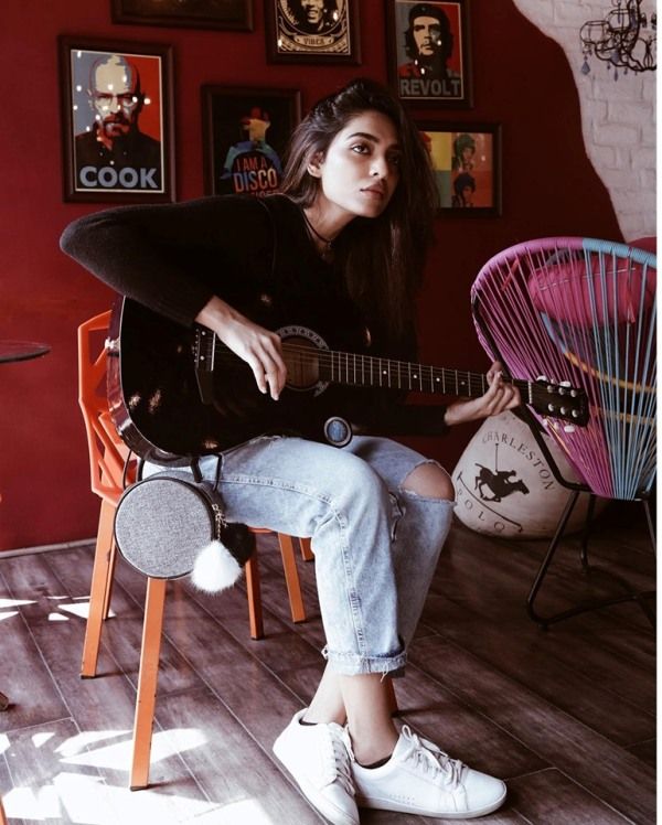 Sobhita Dhulipala playing her guitar