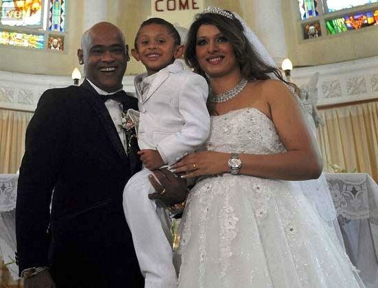 Andrea Hewitt and Vinod Kambli with their son at their church wedding