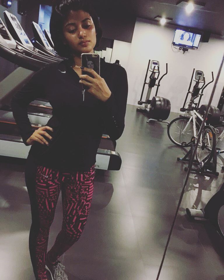 Oviya Helen posing in the gym