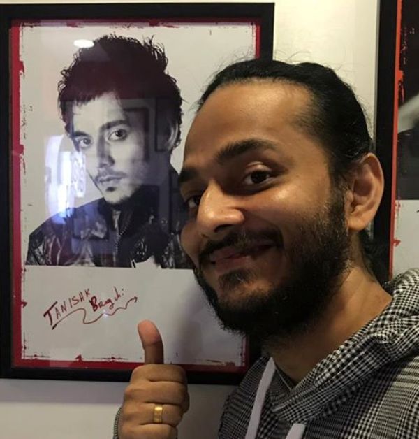 Kanishk Bagchi posing with his photo and Autograph