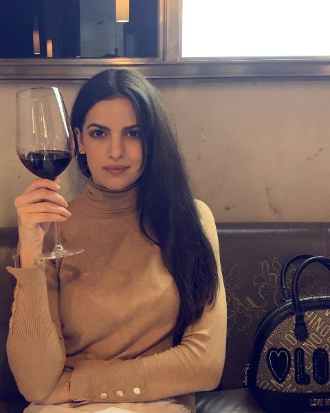 Natasa Stankovic holding a glass of wine