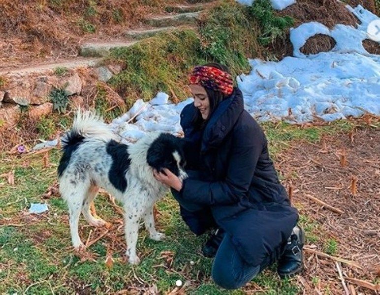Riya Mavi playing with a dog
