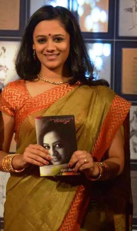 Spruha Joshi Posing with Her Book