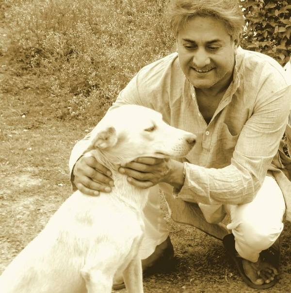 Sarvadaman D Banerjee Playing With a Dog