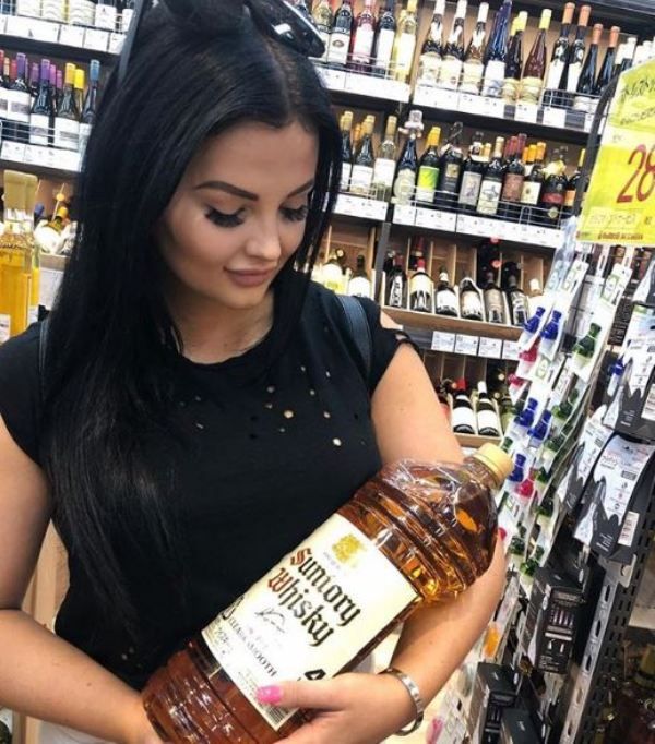 Renee Gracie holding a bottle of whisky