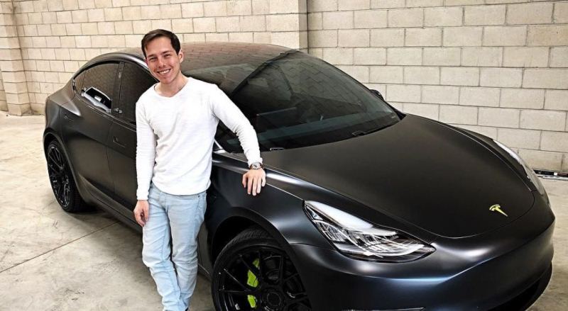 Graham Stephan with his Tesla Model 3