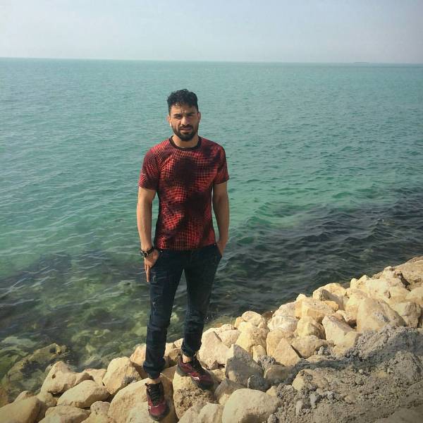 Navid Afkari standing at a seashore
