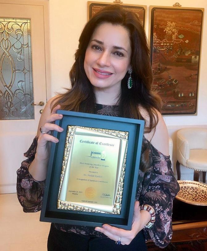Neelam Kothari with an award