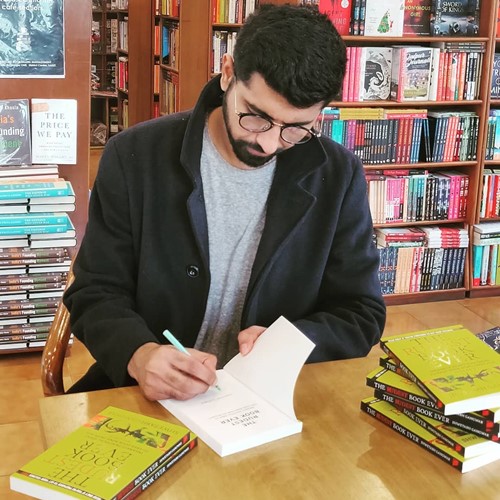 Shwetabh signing his book during its launch at a book store
