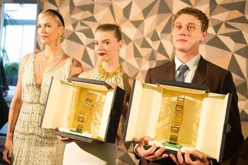 Anya Taylor-Joy (middle) receiving the Trophee Chopard with George MacKay and Charlize Theron