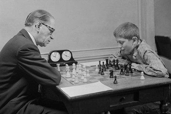 Childhood picture of Bobby Fischer playing chess