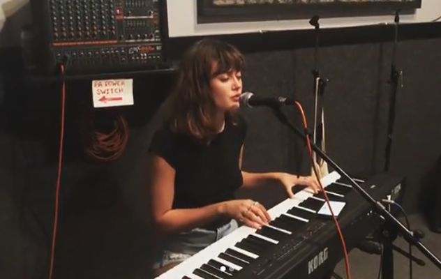 Ella Purnell singing and playing the piano