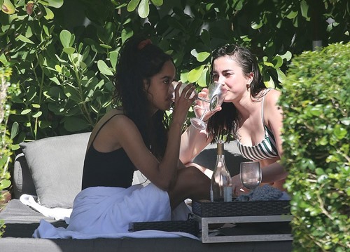 Malia Obama drinking with her friend on a vacation