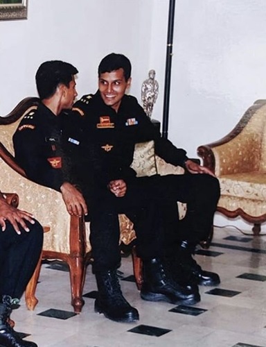 Sandeep Unnikrishnan laughing during conversation with his colleague