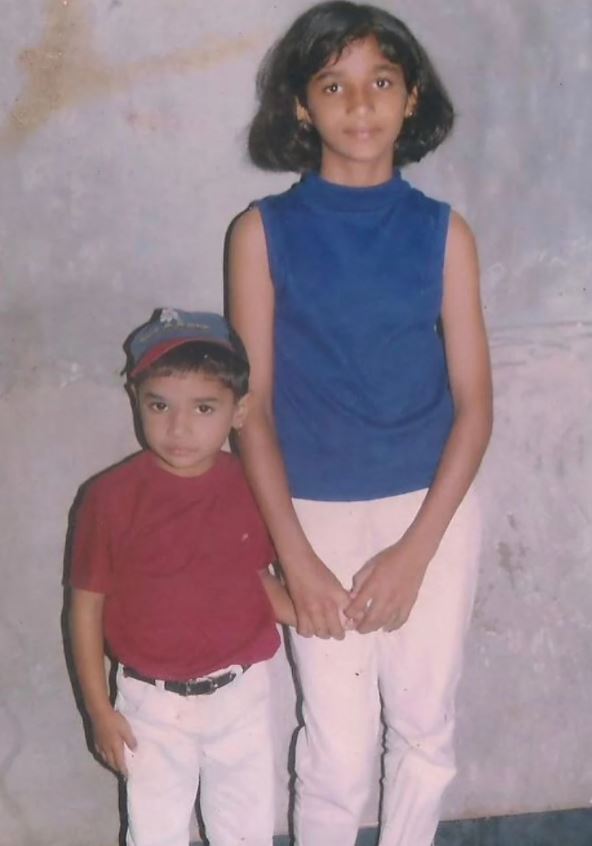 A childhood picture of Divya Uruduga with her younger sibling