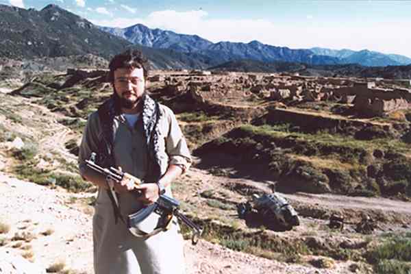 Jamal Khashoggi holding an assault rifle