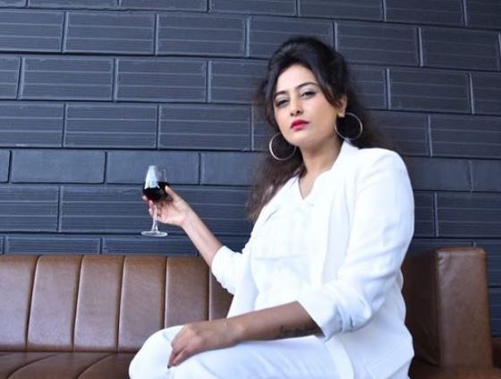 Nidhi Subbaiah with a glass of wine