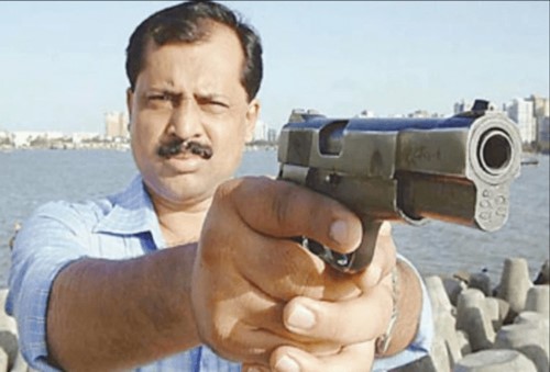 Old picture of Sachin Vaze with a gun
