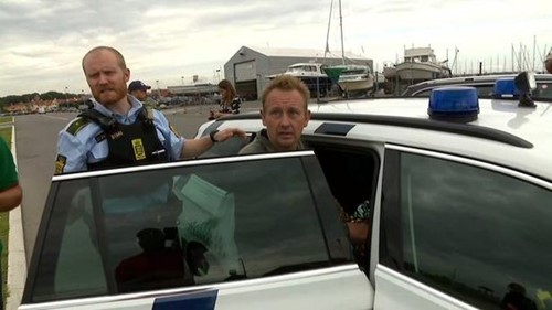 Peter Madsen getting inside a cop car after his arrest