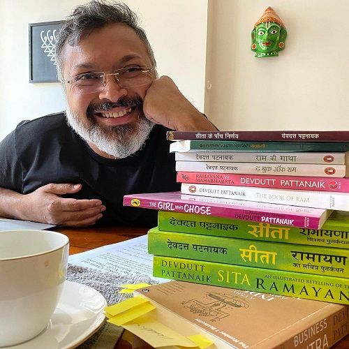 Devdutt Pattanaik displaying his books
