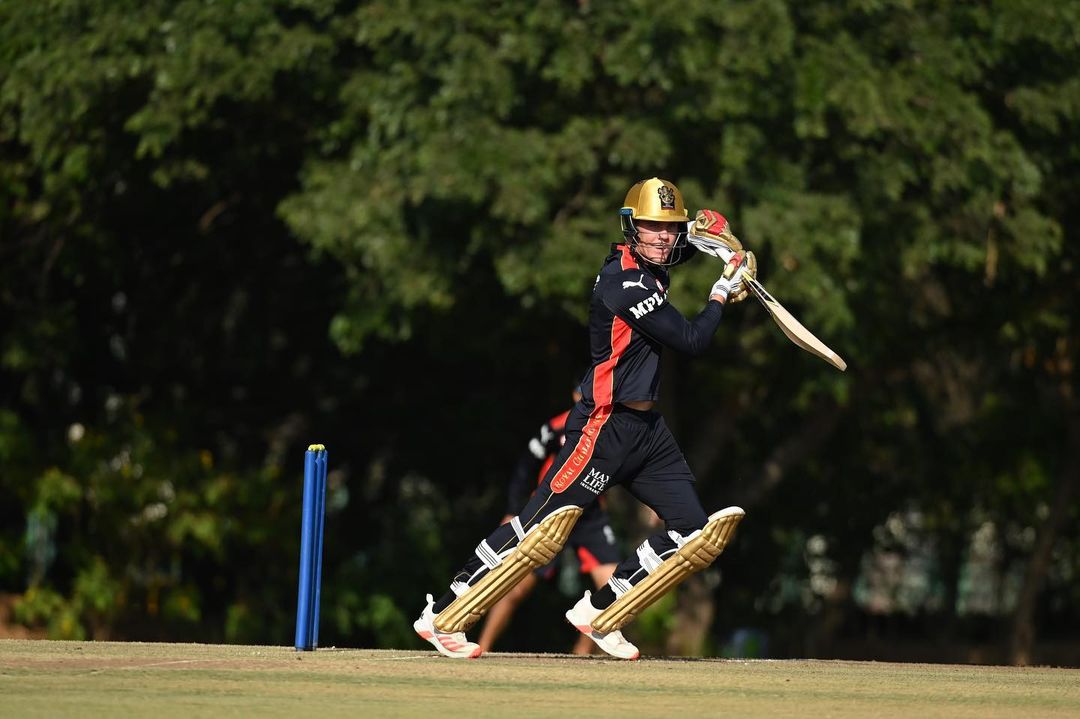 Finn Allen hits one during a practice session for RCB