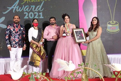 Harshika Poonacha receiving Women's Achiever Award 