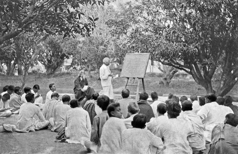 Rabindranath Tagore (seated, to left of man at blackboard) at an open-air classroom, Shantiniketan, West Bengal