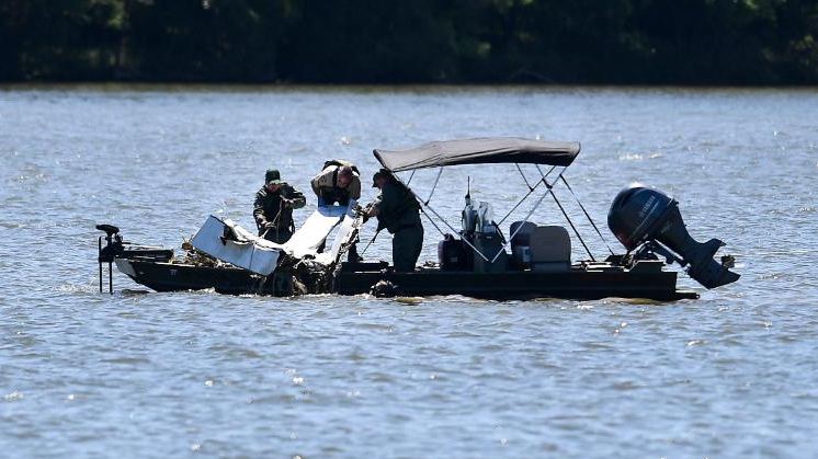 Emergency personnel removing debris of a plane crash from Percy Priest Lake in Smyrna, Tennessee