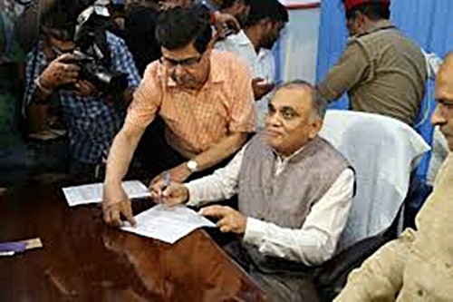 Anup Chandra Pandey signing some documents after becoming Chief Secretary of UP in 2019