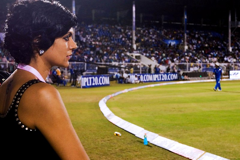 Mandira posing on the cricket playground while working as a cricket host