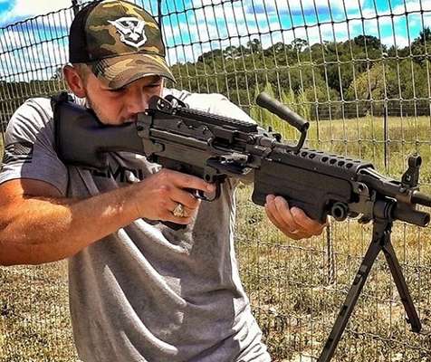 Matt Carriker posing with his M249 light machine gun