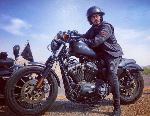 Shahzad Sheikh posing with his Harley Davidson Street Bob