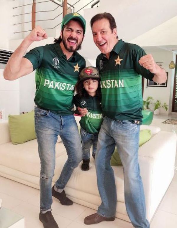 Shahzad Sheikh with his father and son wearing the Pakistani cricket team jersey