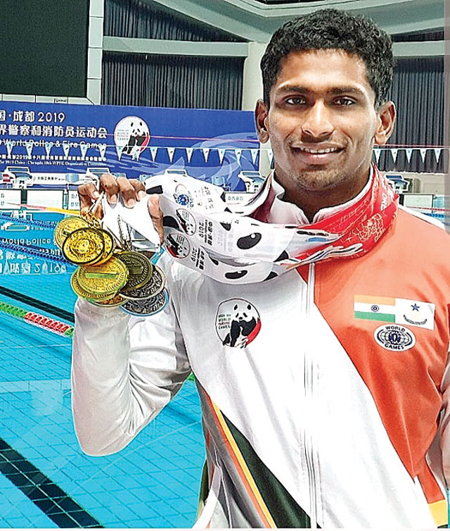 Sajan Prakash showing his Gold medals