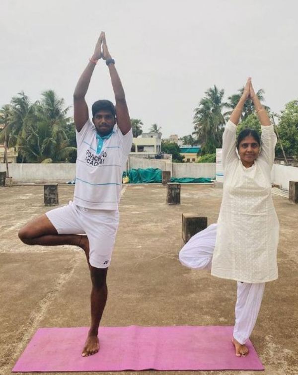 Satwiksairaj Rankireddy practising yoga with his mother