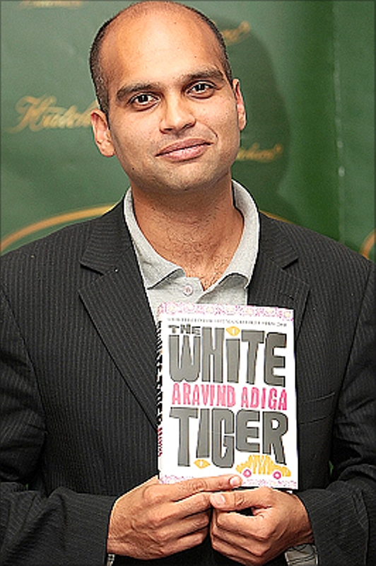 Aravind Adiga with his book The White Tiger