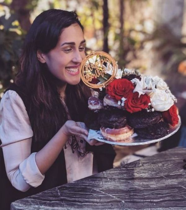 Mira Sethi holding her doughnut birthday cake