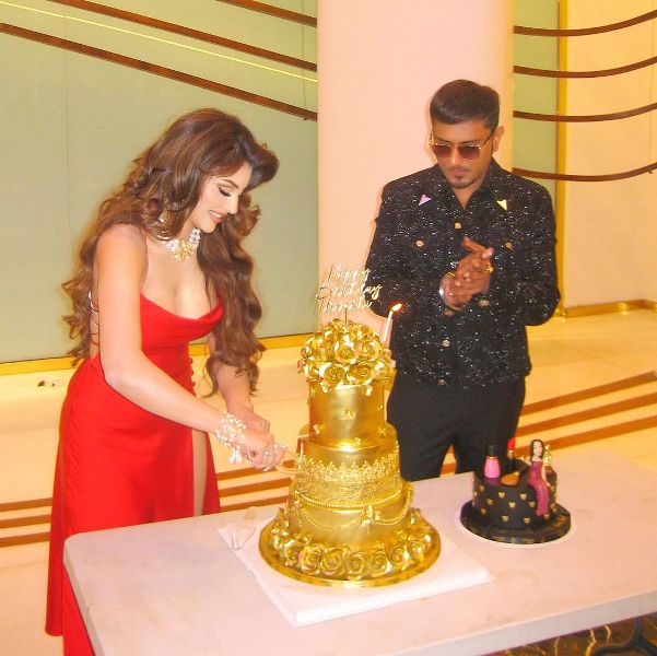 Urvashi Rautela while cutting the 24-carat gold cake that Honey Singh gifted her on her 30th birthday