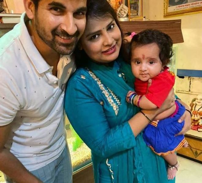 Akshay Waghmare with his wife holding her daughter
